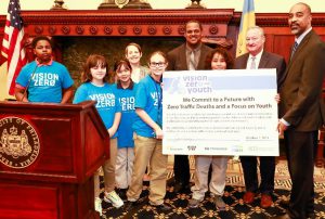 A group gathers behind a podium during the city’s annual Vision Zero update press conference in October 2020.