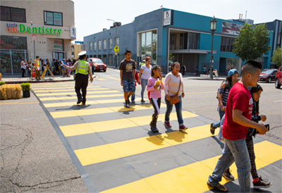 pedestrians utilizing a crosswalk with a crossing guard present